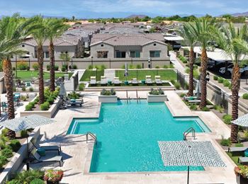 a large swimming pool with detached homes at Pillar Lago in Peoria, AZ